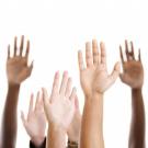 Image of hands raised as if taking attendance